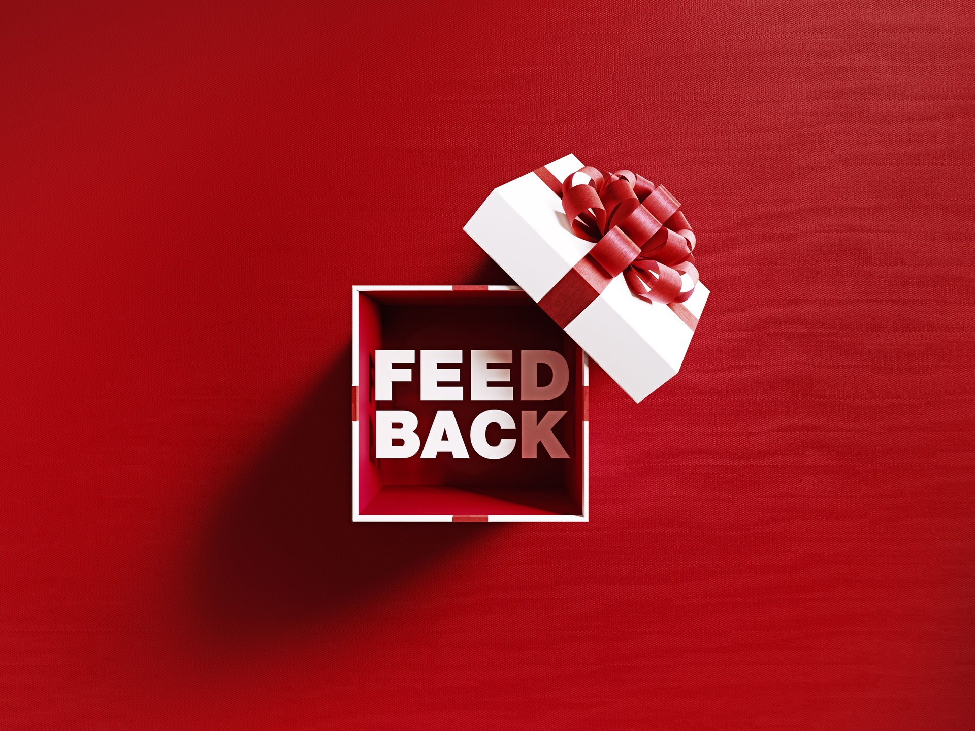 Feedback Text Coming Out Of A White Gift Box Tied With Red Ribbon